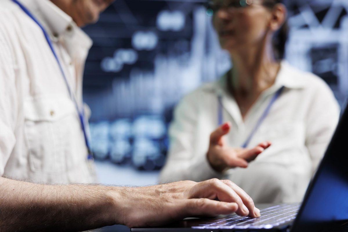 cloud-computing-business-executives-discussing-how-prevent-blade-servers-strains-caused-by-ai-applications-driving-up-power-usage-hardworking-operators-maintenancing-mainframes-close-up